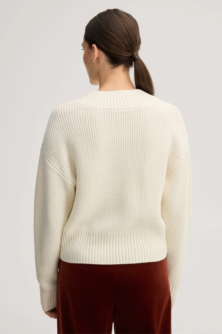 Leads to product detail page "Ecru merino knit jumper with a V-neck"