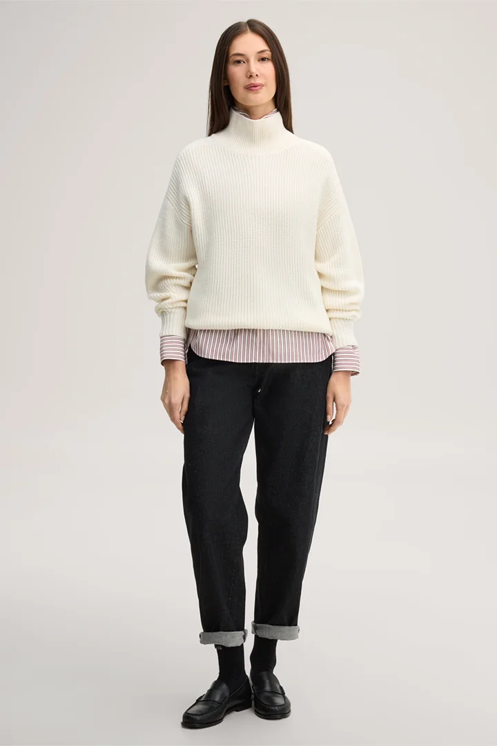 Leads to product detail page "Ecru merino wool jumper with a stand-up collar"