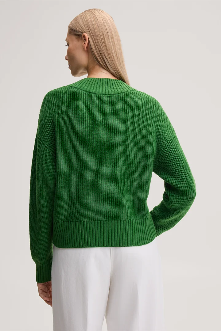Leads to product detail page "Green merino wool v-neck jumper"