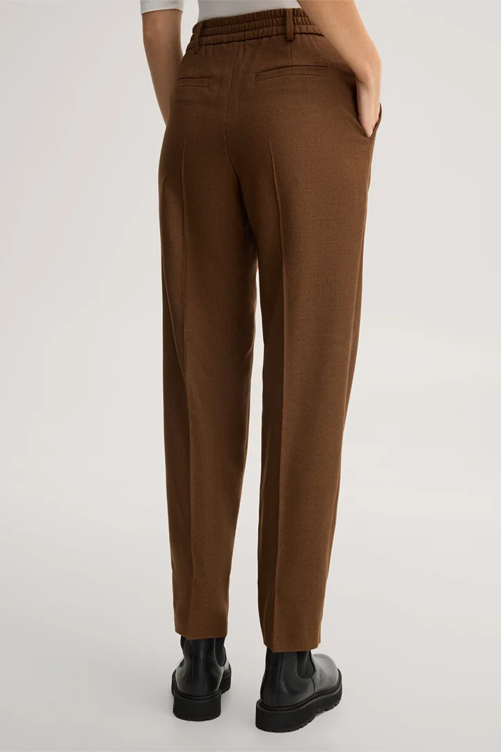 Leads to product detail page "Jogger-style trousers in a virgin wool blend with pleats, in brown"