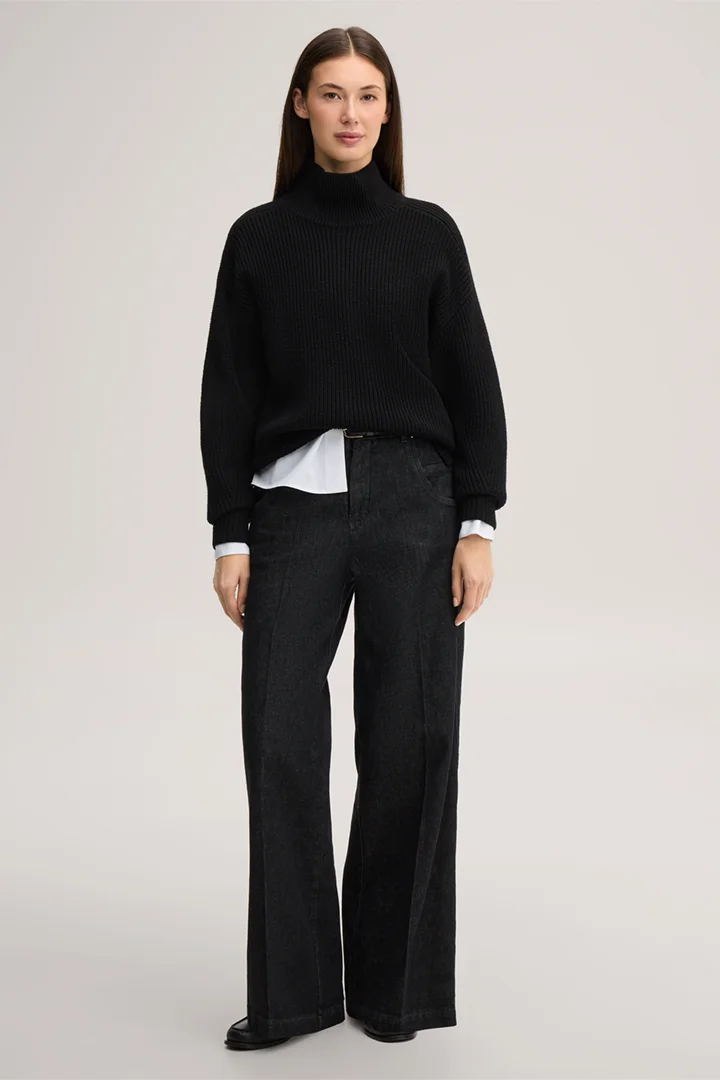 Leads to product detail page "Black merino wool jumper with a stand-up collar"