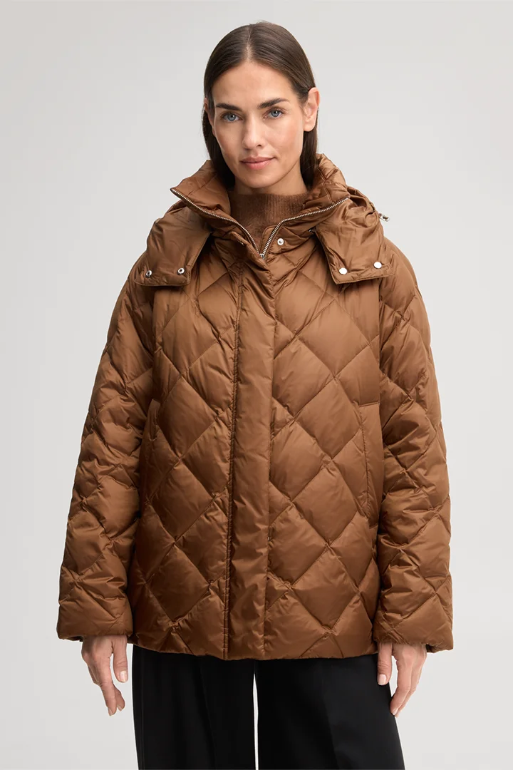 Leads to product detail page "Nylon quilted jacket with a stand-up collar in caramel"