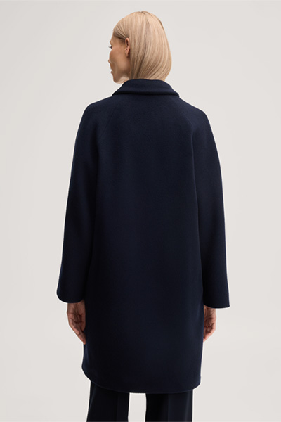 Leads to product detail page "Brushed wool short coat in navy blue"