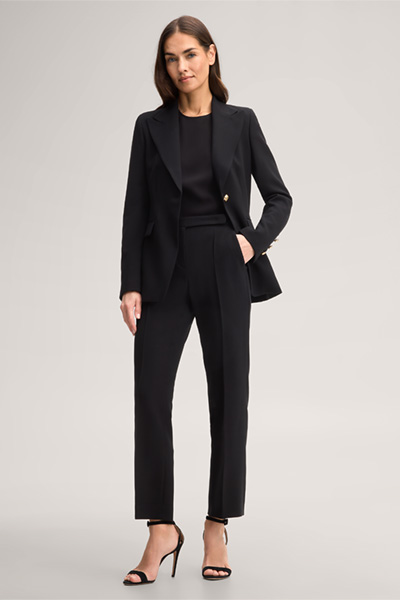 Leads to product detail page "Black wool crepe straight cut trousers"
