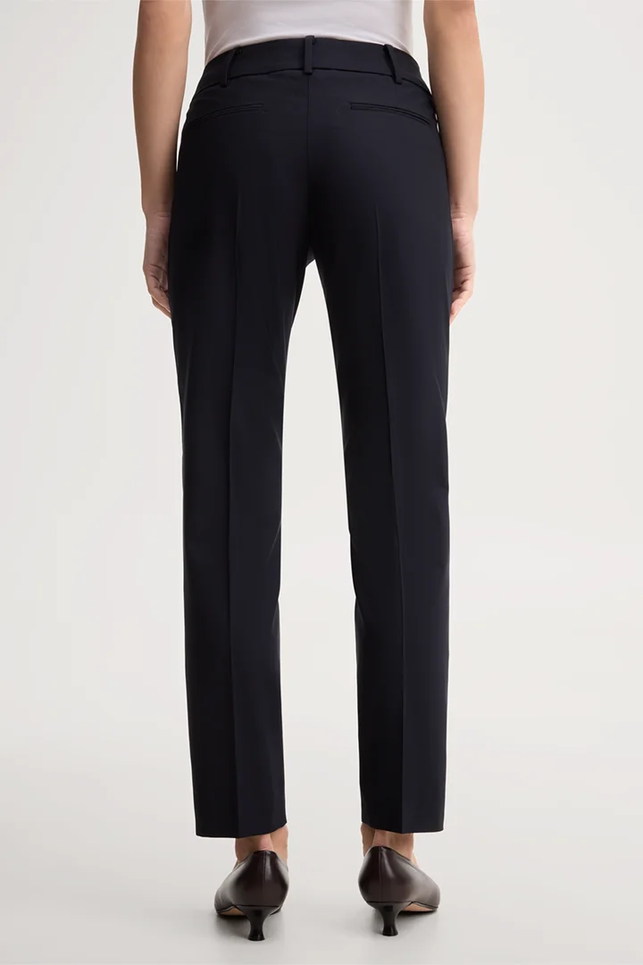Leads to product detail page "Navy blue virgin wool stretch cigarette pants"