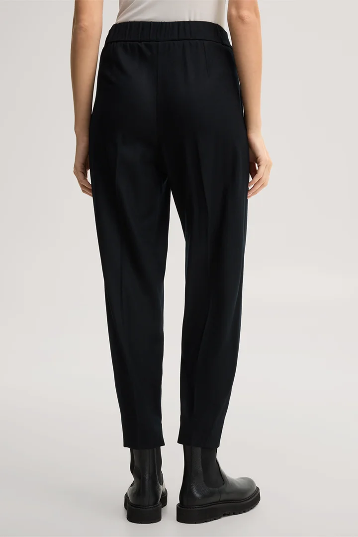 Leads to product detail page "Black flannel and wool jersey balloon trousers"
