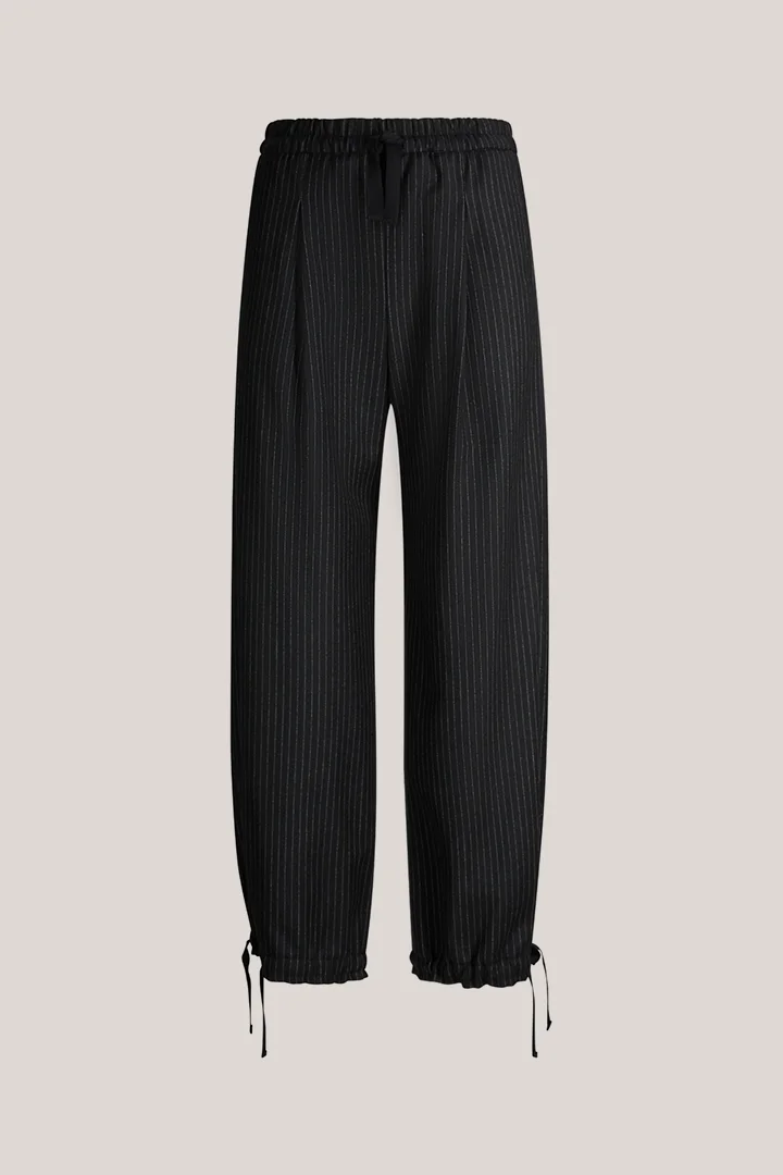 Leads to product detail page "Black virgin wool pinstripe balloon trousers"