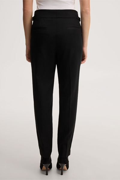 Leads to product detail page "Black virgin wool flannel pleated trousers"