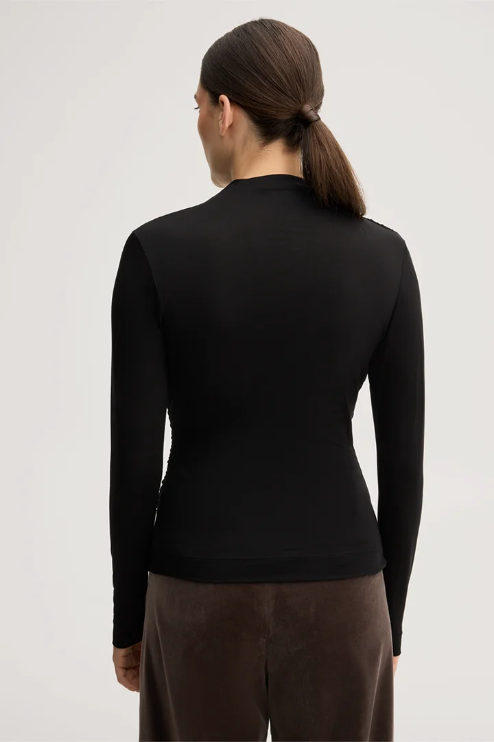Leads to product detail page "Black lyocell stretch jumper with a stand-up collar"