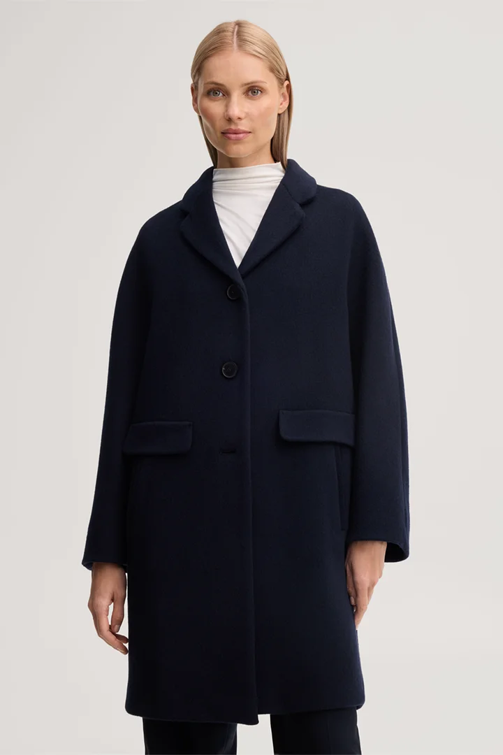 Leads to product detail page "Brushed wool short coat in navy blue"