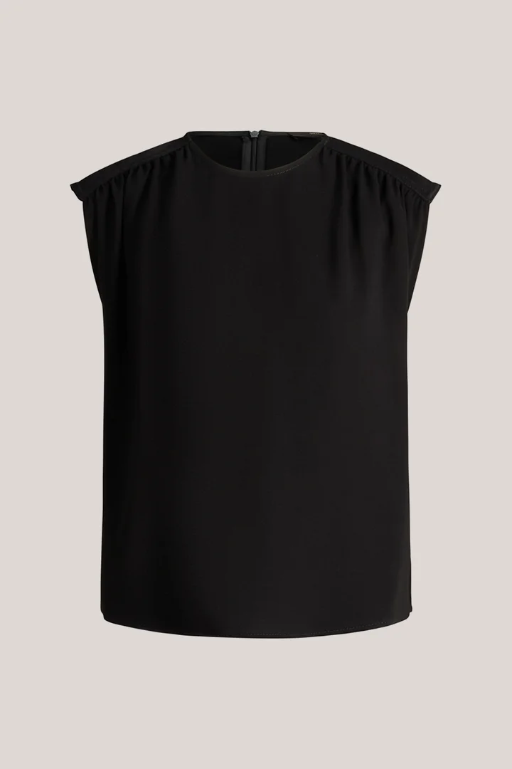 Leads to product detail page "Black crepe blouse top"