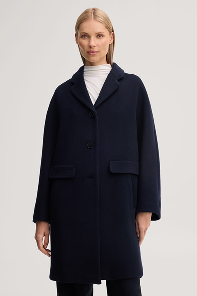 Leads to product detail page "Brushed wool short coat in navy blue"