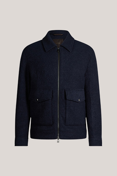 Leads to product detail page "Navy blue woollen zip-up jacket with a shirt collar"