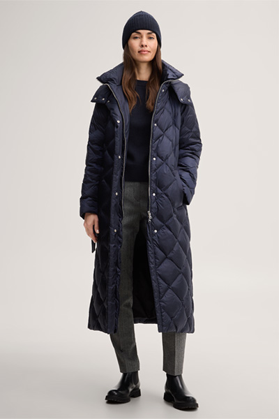 Leads to product detail page "Nylon down-filled quilted coat with stand-up collar in navy blue"