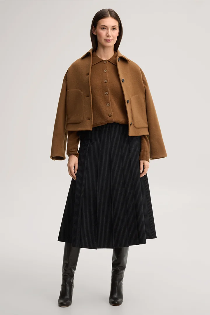 Leads to product detail page "Cashmere cardigan with a polo collar in caramel"