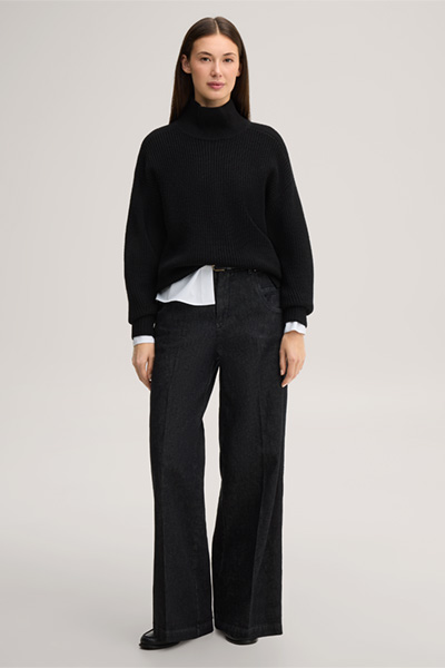 Leads to product detail page "Black merino wool jumper with a stand-up collar"