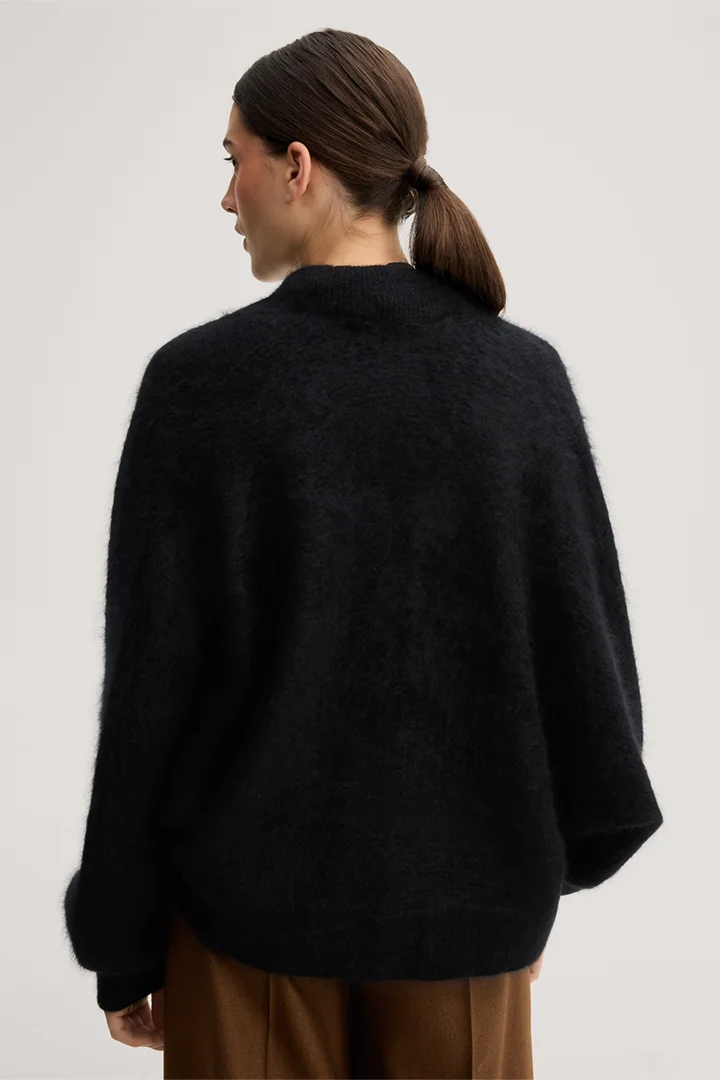 Leads to product detail page "Brushed cashmere cape jacket in black"