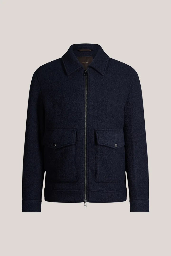 Leads to product detail page "Navy blue woollen zip-up jacket with a shirt collar"