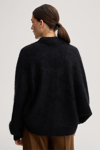 Leads to product detail page "Brushed cashmere cape jacket in black"