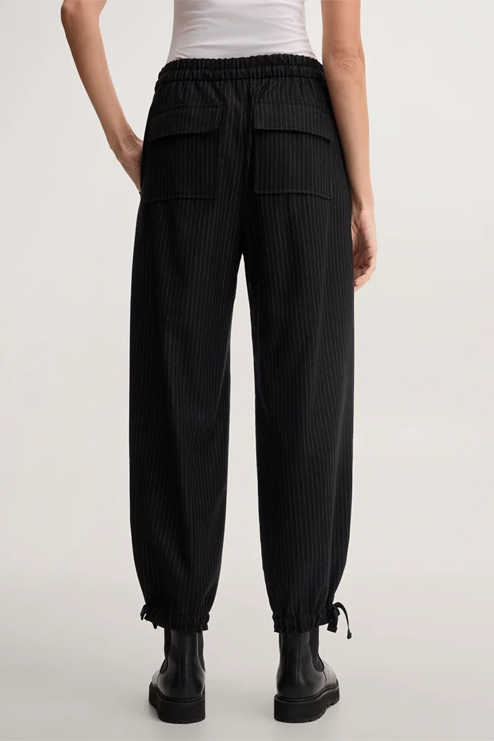 Leads to product detail page "Black virgin wool pinstripe balloon trousers"