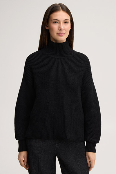Leads to product detail page "Black merino wool jumper with a stand-up collar"
