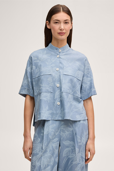 Leads to product detail page "Viscose-linen blend shirt-blouse with stand-up collar in light blue and ecru"