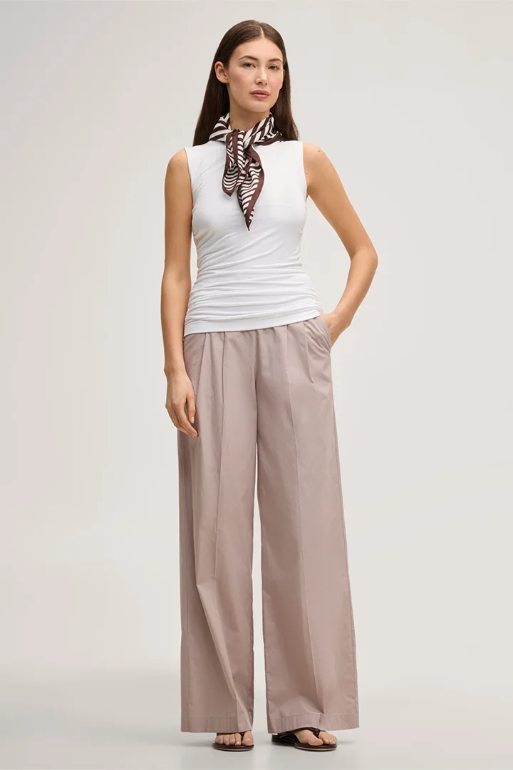 Leads to product detail page "White tencel stretch top with ruffles"