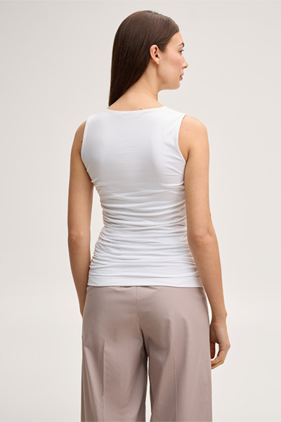 Leads to product detail page "White tencel stretch top with ruffles"