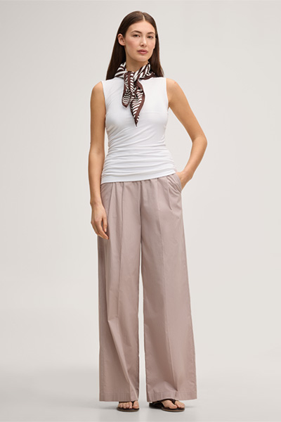 Leads to product detail page "White tencel stretch top with ruffles"