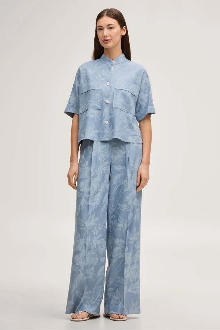 Leads to product detail page "Viscose-linen blend shirt-blouse with stand-up collar in light blue and ecru"