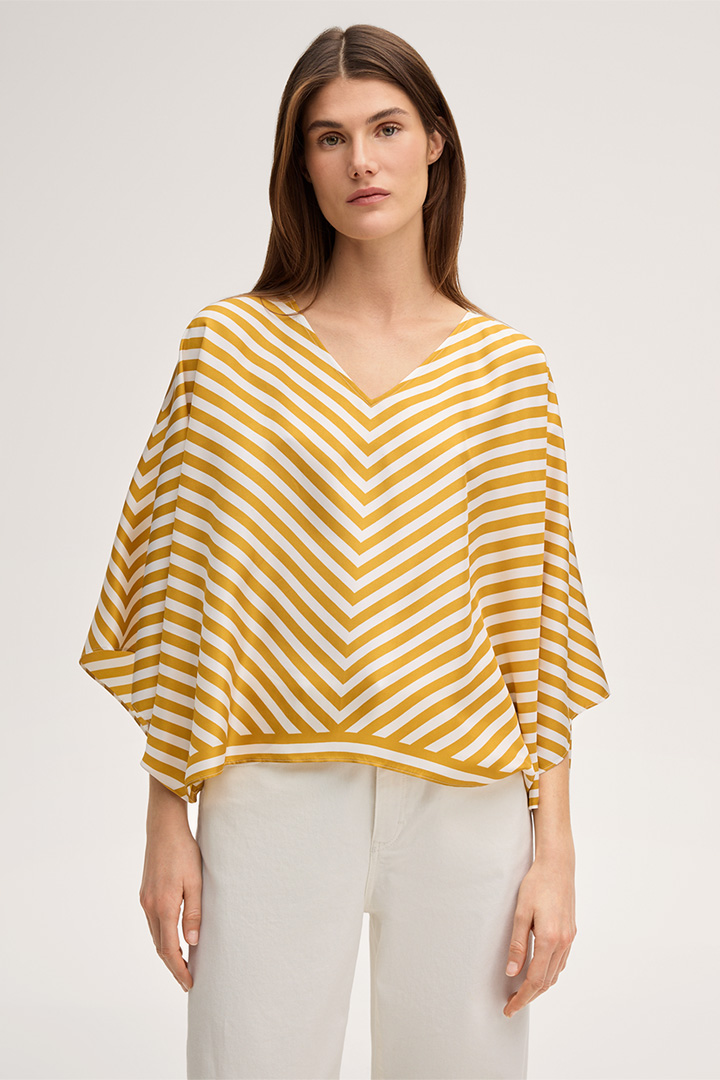 Leads to product detail page "Silk poncho without sleeves in ecru yellow stripes"