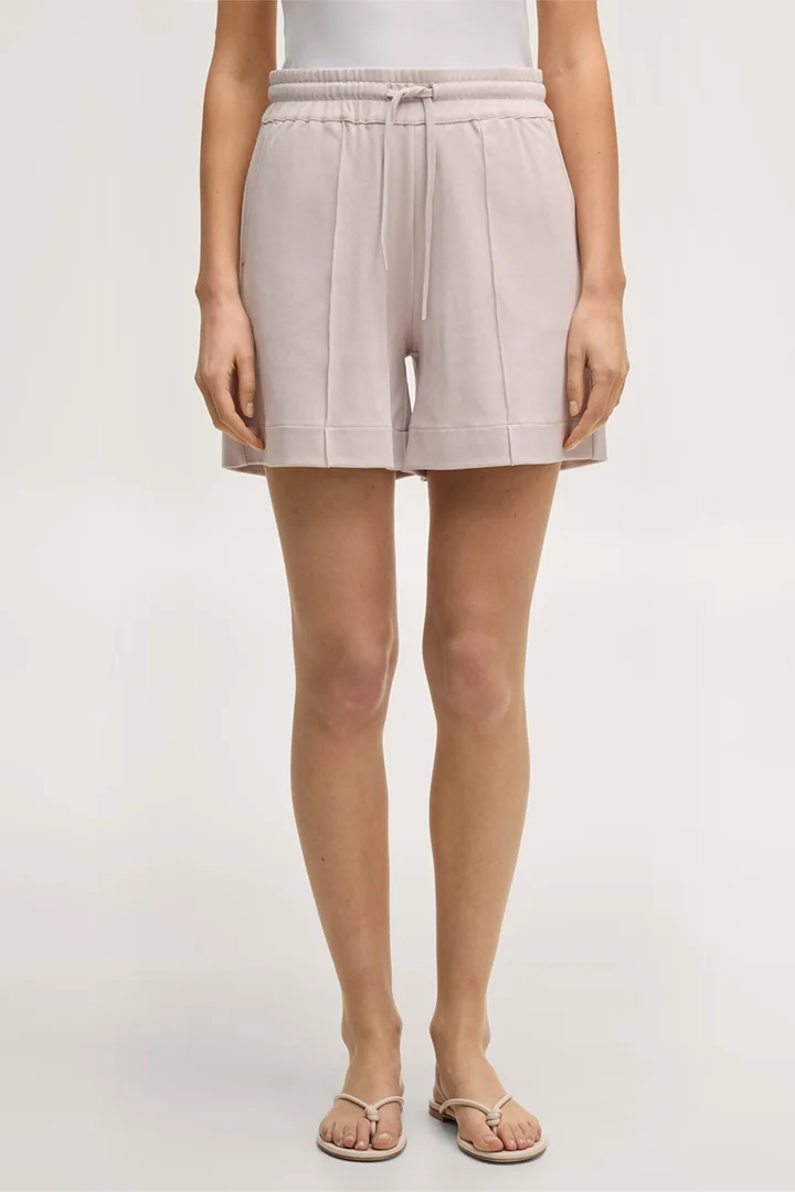 Leads to product detail page "Beige cotton sweat shorts"